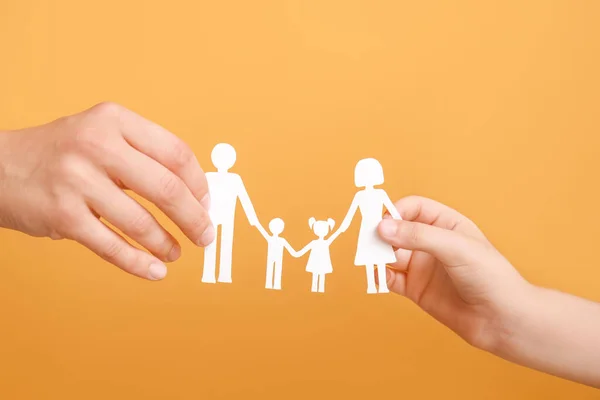 Hands of family with human figures on color background