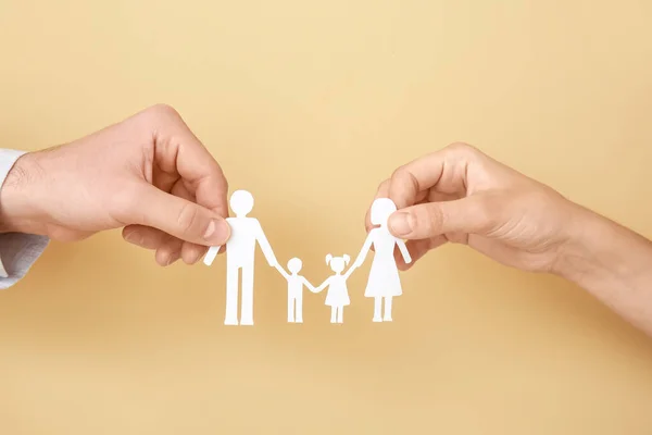 Hands of family with human figures on color background