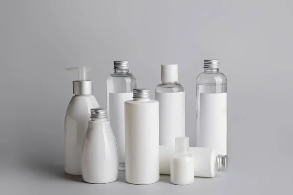 Different Bottles Cosmetic Products Gray Background — Stock Photo, Image