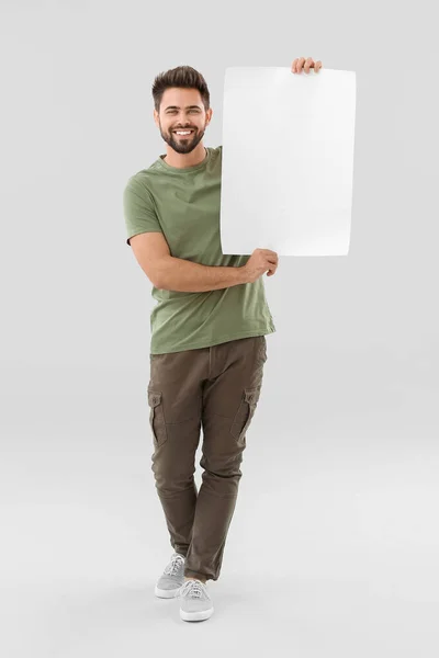 Young Man Blank Paper Sheet Light Background — Stock Photo, Image