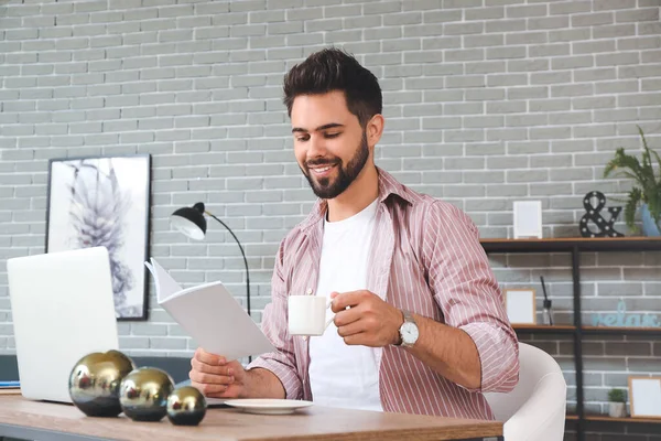 Young Man Laptop Reading Magazine Drinking Tea Home — Stock Photo, Image