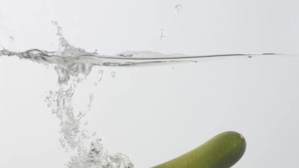 Fallande Färsk Zucchini Vatten Mot Ljus Bakgrund — Stockvideo