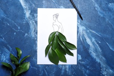 Drawn woman in dress made of green leaves on color background clipart