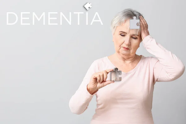 Elderly Woman Suffering Mental Disability Puzzle Piece Grey Background — Stock Photo, Image