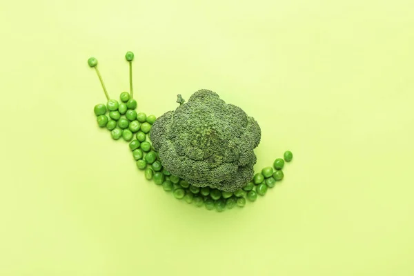 Snail made of vegetables on color background