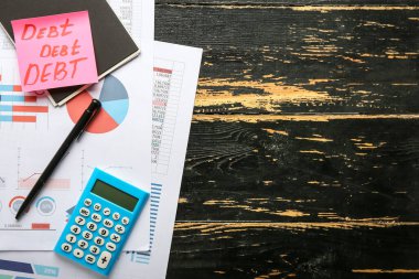 Belgeler ve hesap makinesi masada. Borç kavramı