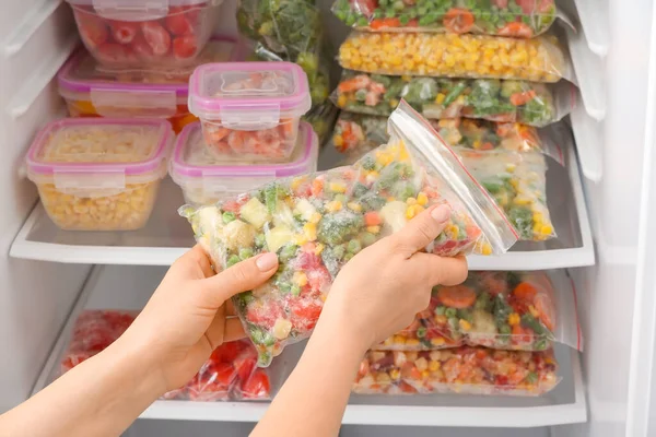 Woman Putting Plastic Bag Frozen Vegetables Refrigerator — Stock Photo, Image