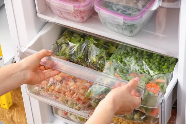 Woman Putting Plastic Bag Frozen Vegetables Refrigerator — Stock Photo, Image