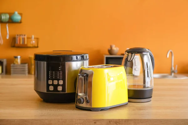 Toaster, multicooker and electric kettle in modern kitchen