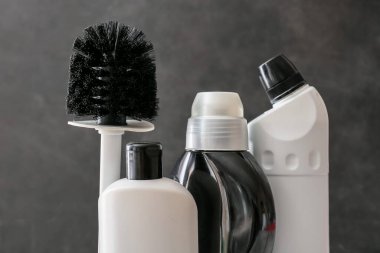 Koyu arkaplanda temizlik malzemeleri var.