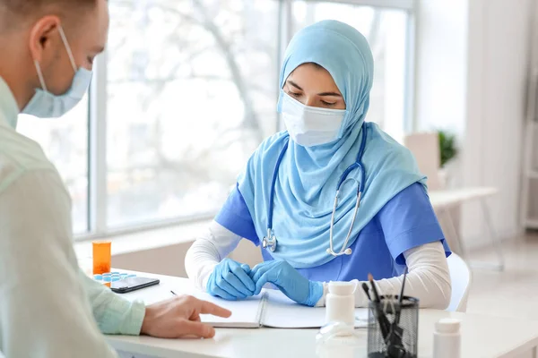 Young man visiting doctor in clinic