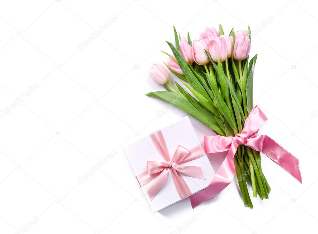 Bouquet of beautiful flowers and gift on white background