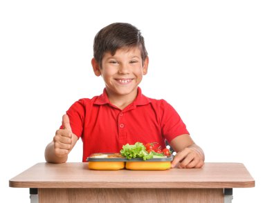 Masasında beyaz arka planda beslenme çantası olan öğrenci.