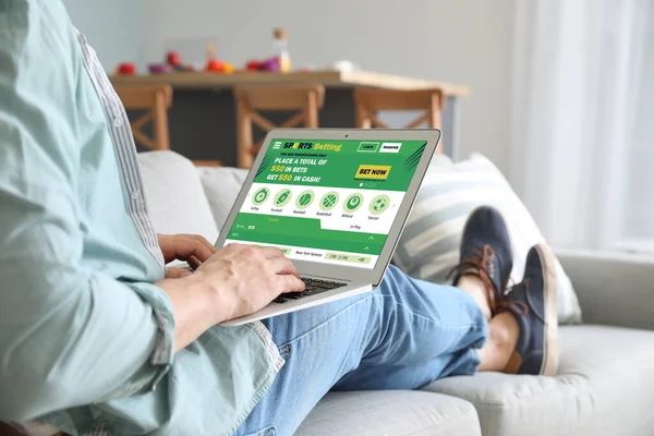 Young man placing sports bet at home