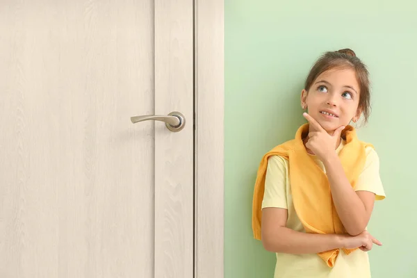 Thoughtful Little Girl Standing Closed Door — Stock Photo, Image