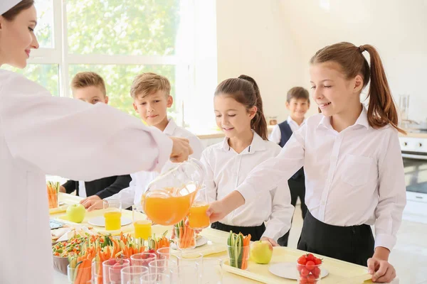 Pupils receiving lunch in school canteen