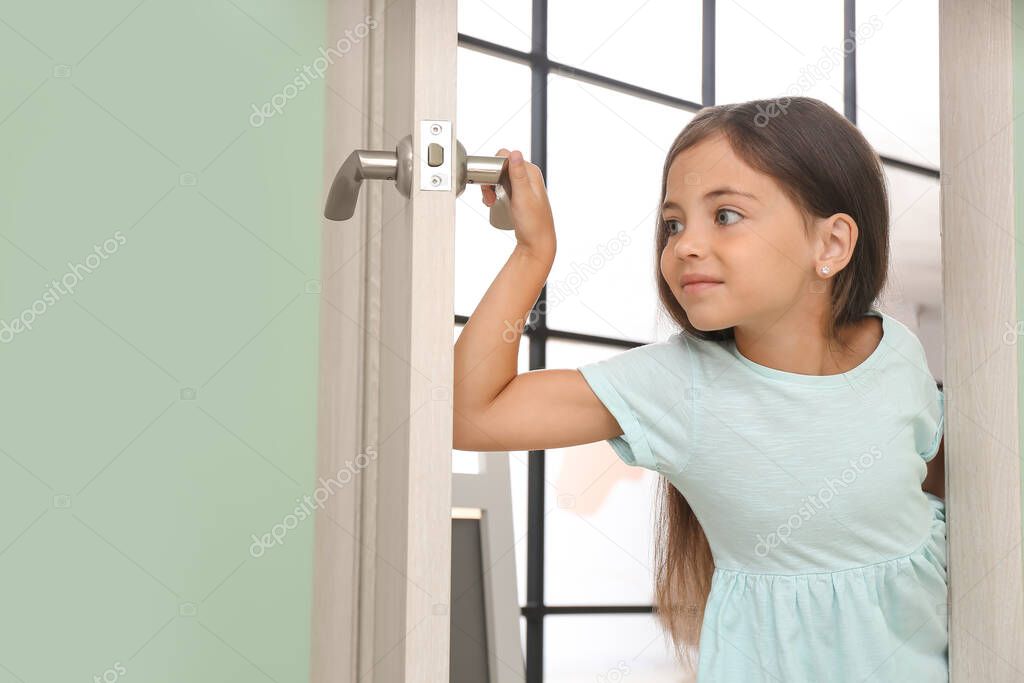 Cute little girl looking out the door