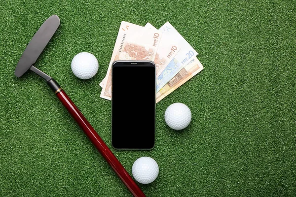 Money, golf club and mobile phone on color background. Concept of sports bet