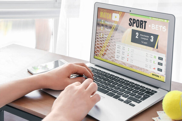 Man placing sports bet at home