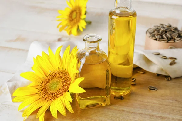 Bottles Oil Seeds Sunflowers Wooden Background — Stock Photo, Image