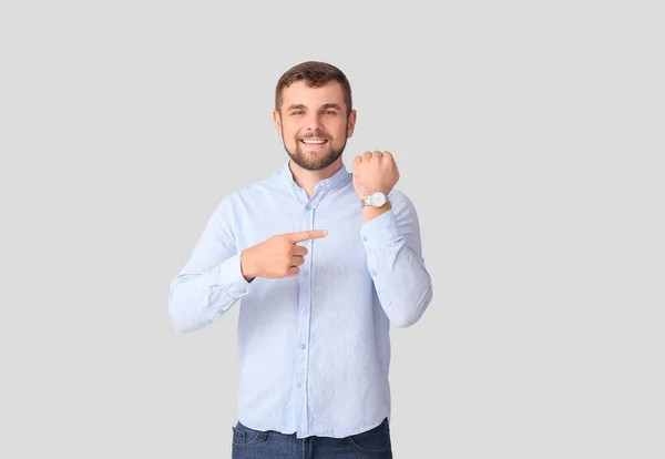 Handsome Man Pointing Wristwatch Light Background — Stock Photo, Image