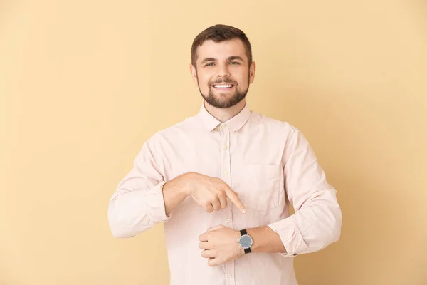 Hombre Guapo Apuntando Reloj Pulsera Sobre Fondo Color — Foto de Stock