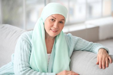Mature woman after chemotherapy at home clipart