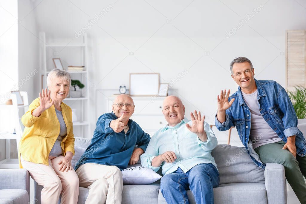 Senior people sitting on sofa at home