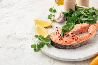 Çiğ somon bifteği, otlar ve baharatlarla dolu bir tabak.