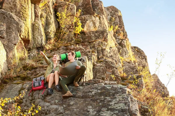 Couple of young tourists in mountains