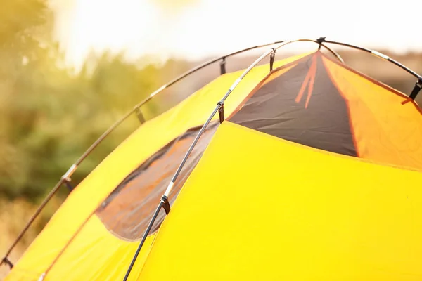 Camping tent in countryside on sunny day