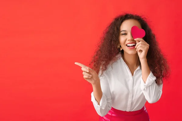 Mulher Afro Americana Com Coração Vermelho Mostrando Algo Fundo Cor — Fotografia de Stock