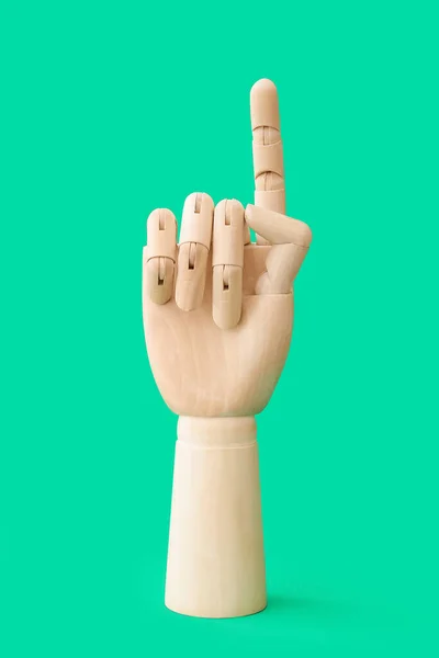 Wooden Hand Raised Index Finger Color Background — Stock Photo, Image