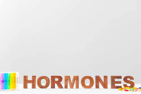 Word Hormones Pills Light Background — Stock Photo, Image