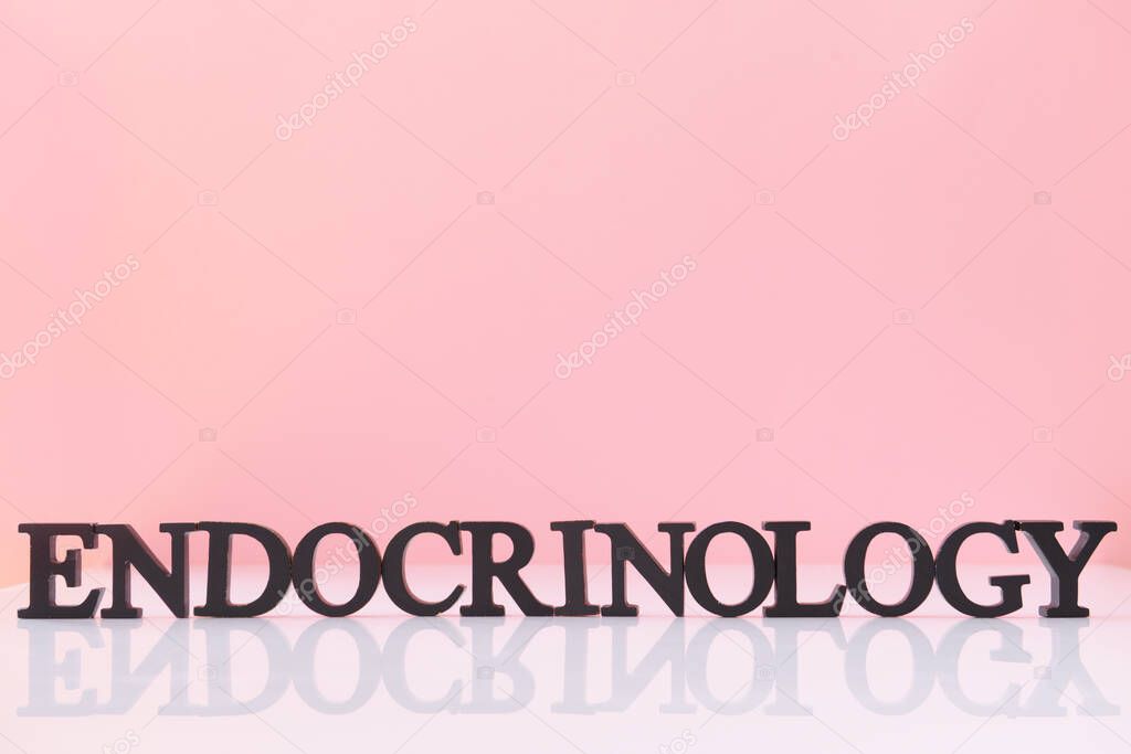 Word ENDOCRINOLOGY on table against color background