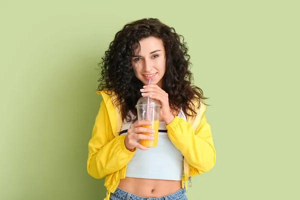 色の背景にジュースのカップとスタイリッシュな若い女性の肖像画 — ストック写真