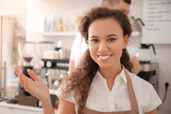 Young barista working in cafe