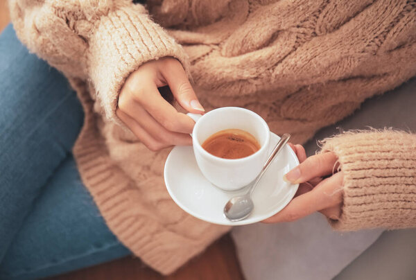 Beautiful woman drinking hot espresso in cafe, closeup