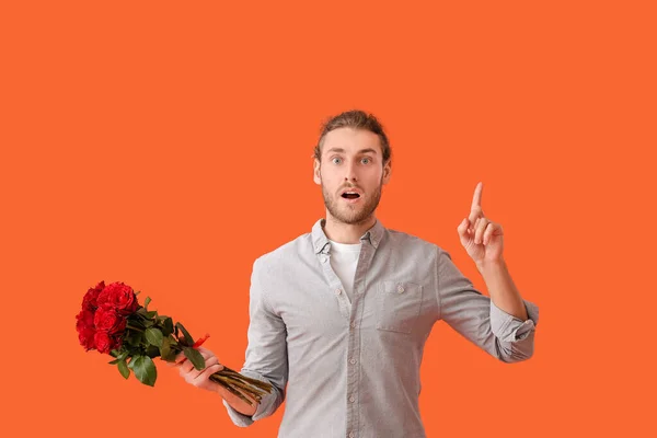 Young Man Flowers Raised Index Finger Color Background Valentine Day — Stock Photo, Image