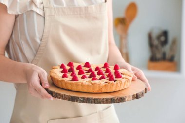 Mutfakta lezzetli ahududulu turtası olan kadın, yakın plan.