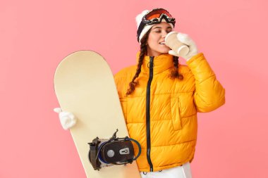 Kadın snowboardcu kahve içiyor.