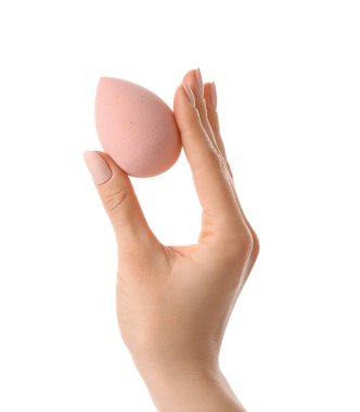 Beyaz arkaplanda makyaj süngeri olan el