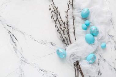 Beautiful Easter eggs and pussy willow on light background