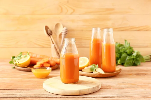 Bottles Tasty Carrot Juice Wooden Table — Stock Photo, Image