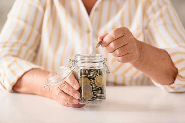 Äldre Kvinna Som Lägger Mynt Burk Vid Bordet Begreppet Pension — Stockfoto
