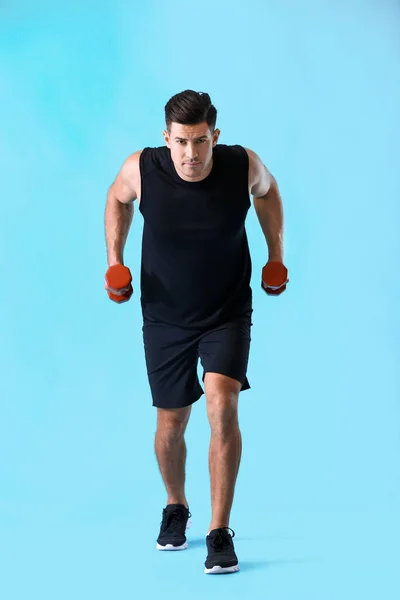 Sporty Young Man Training Dumbbells Color Background — Stock Photo, Image