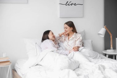 Genç lezbiyen çift yatakta dinleniyor.