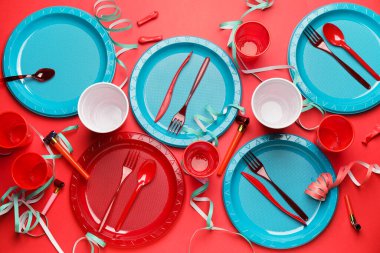 Renkli arkaplanda plastik sofra takımı ve konfeti