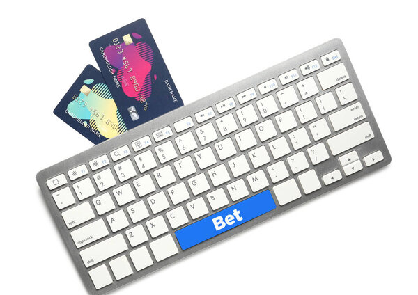 Credit cards with computer keyboard on white background. Online betting