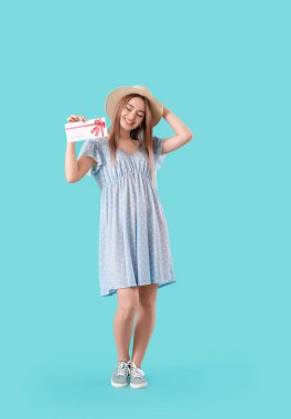 Arkaplanda hediye kartı olan güzel bir genç kadın.